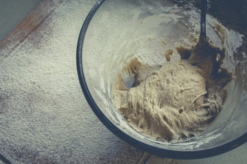 Rye Buckwheat dough rising in a bowl with a flour board dusted and used for baking