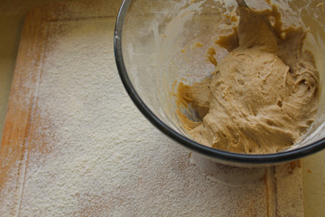 Rye Buckwheat dough rising in a bowl with a flour board dusted and used for baking