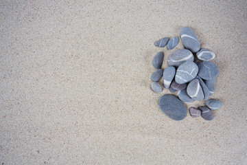 Fototapeta na wymiar sea pebbles on sand background