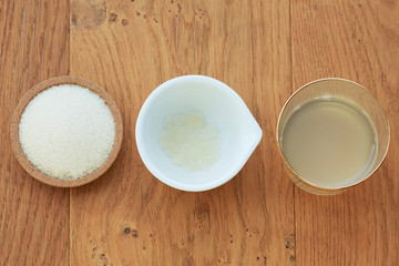 A flatlay overhead shot of the ingredients in line for water kefir drink, including dried dates and...