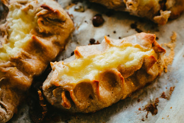 Cooked Karelian pies - Pirakka on a baking sheet. Dish of national cuisine - piirakka. Close-up.