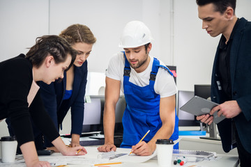Engineers discussing the construction plan in their office