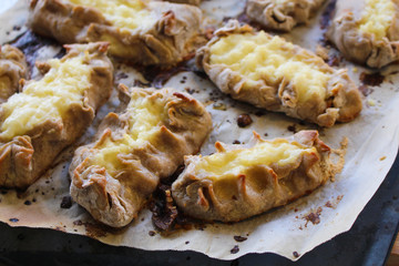 Cooked Karelian pies - Pirakka on a baking sheet. Dish of national cuisine - piirakka. Close-up.