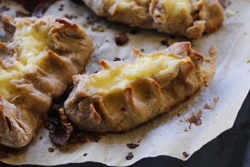 Cooked Karelian pies - Pirakka on a baking sheet. Dish of national cuisine - piirakka. Close-up.