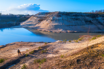 The man opposite the high mountain and the lake.