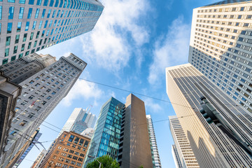 Fototapeta na wymiar Downtown San Francisco city skyscrapers against blue sky, upward view from the street
