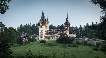 Fototapeta na wymiar Peles Castle, famous residence of King Charles I in Sinaia, Romania. Summer landscape at dawn of royal palace and park.