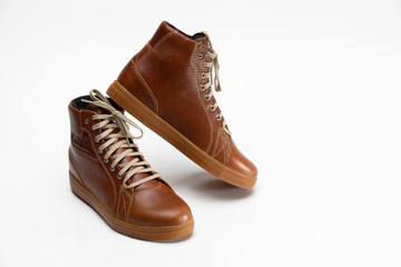 Closeup of Motorcyclist Tan Leather Protective Boots. Against White Background.