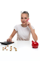 Money Saving Concepts. Teenager Blond Girl Posing With Coins and Moneybox. Calculating Income With Calculator For Savings.