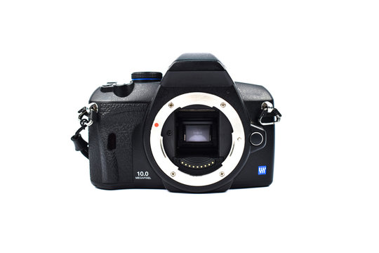 A black digital camera without a lens placed on top of a white background
