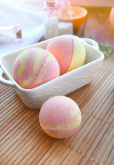 Spa resort treatment. Still life image with bath bombs on wooden background. Spring or summer relax concept. Eco bodycare or skincare cosmetics