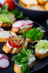 toasted breads of baguette with cream cheese and vegetables