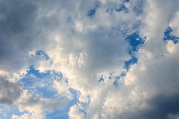 the sun shining through the clouds against the blue sky, light clouds in the sky