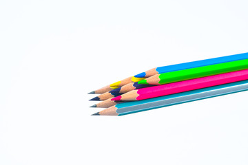 Fototapeta premium Stack of different colored wood pencil crayon placed on top of a white background