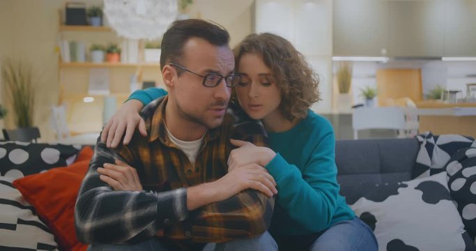 Young woman helping husband to calm down