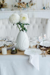 Easter festive elegant home table setting decor, decorated table for traditional holiday dinner, decorated with spring flowers, Easter decor, white napkins and eggs