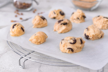 Uncooked cookies with chocolate on table, closeup