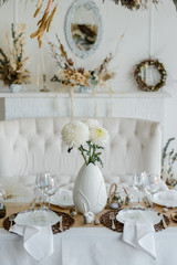Easter festive elegant home table setting decor, decorated table for traditional holiday dinner, decorated with spring flowers, Easter decor, white napkins and eggs