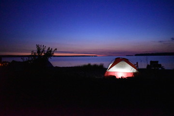 Fototapeta na wymiar Lit tent at sunset 