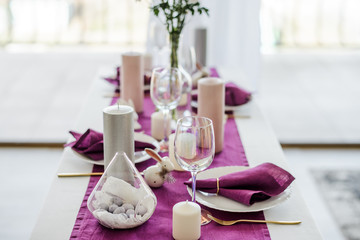 Festive table setting with marsala violet textile napkin and tablecloth, easter eggs, white dish...