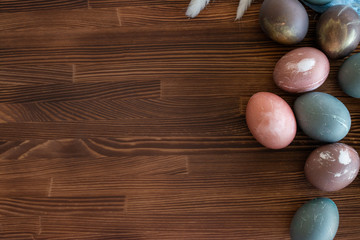 Happy easter egg. set of Holiday eggs on  brown wooden   backround, copy space. Natural  colorful eggs painted in pastel colors , happy Easter concept.