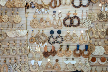 Colorful handmade earrings for sale for tourists at the street market in Hoi An old town, Vietnam