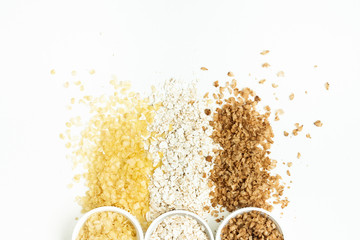 Different types of cereals isolated on white background. oatmeal, buckwheat, millet, rice, for express cooking porridge. Flat lay composition