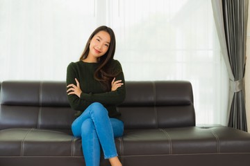 Fototapeta premium Beautiful portrait young asian woman sit relax on sofa