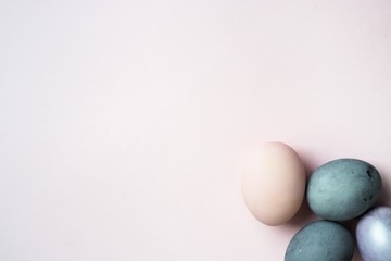 painted Egg shaped and space for text on pink background, flat lay. Easter celebration concept