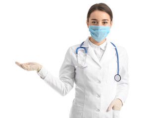 Doctor in medical mask showing something against white background