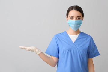 Doctor wearing medical mask against grey background