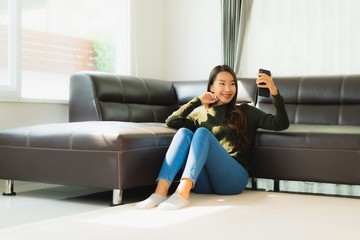 Portrait beautiful young asian woman use smart mobile phone with coffee cup