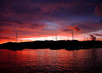 Fototapeta premium Boats at sunset in a paradise anchorage.