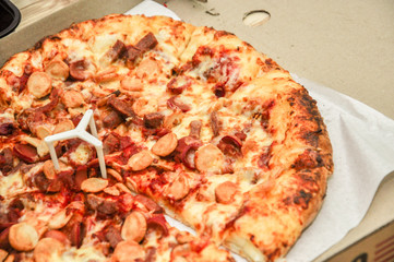 A Pan of pizza full with meat and cheese topping.