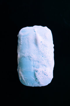 Bar Of Soap With Foam Bubbles On Black Background. Top View.