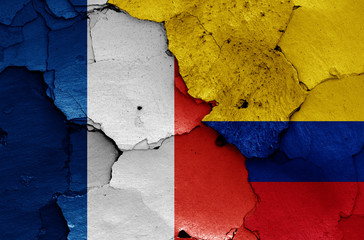 flags of France and Colombia painted on cracked wall