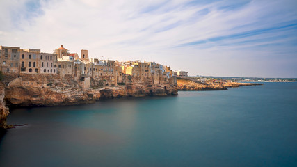 Houses on dramatic cliffs over Adriatic Sea On A Sunny Autumn Day - Long Exposure - Polignano a Mare- Apulia - Italy