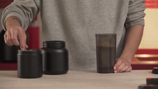 Serving A Portion Of Protein Powder and creatine Into The Shaker bottle