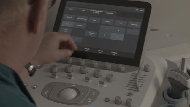 ultrasound doctor examines a pregnant girl, belly of a pregnant girl