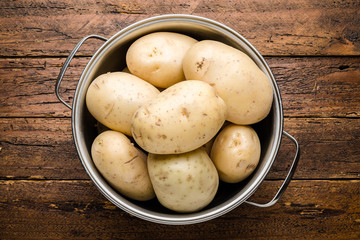 Top view fresh organic potatoes on table top