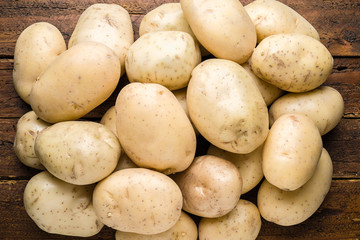 Top view fresh organic potatoes on table top