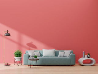 Modern living room interior with sofa and green plants,lamp,table on living coral color wall background.