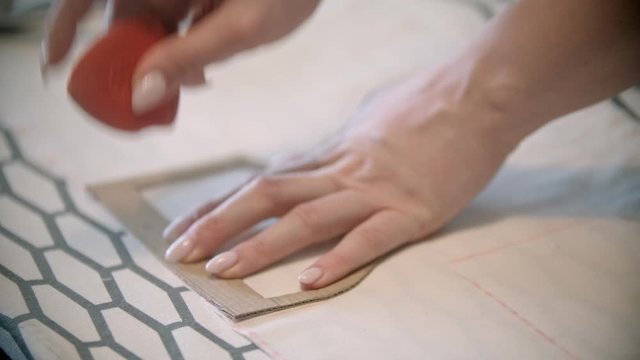 Young seamstress making marks using the soap and form