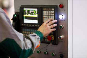 operator programs the CNC manufacturing machine
