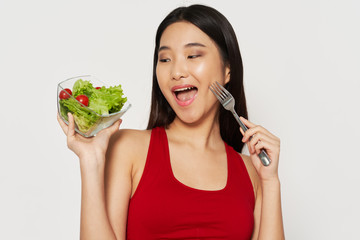 young woman eating salad