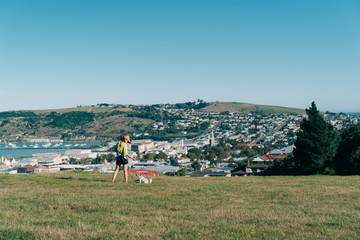 Young attractive walking with a dog in the park Oamaru, New Zealand.