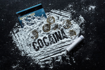 Closeup to a cocaine spanish lettering word over cocaine lines, colombian coins, colombian money...