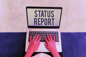 Writing note showing Status Report. Business concept for document relating a situation of something such as a project