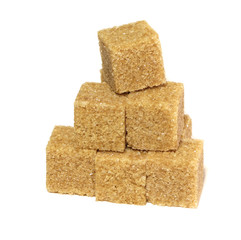 Cane sugar isolated on a white background. Brown whole cane sugar. Cubes of cane sugar