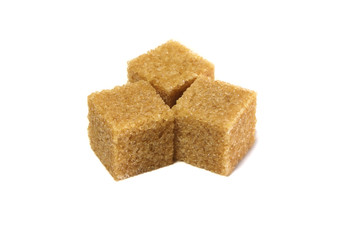 Cane sugar isolated on a white background. Brown whole cane sugar. Cubes of cane sugar